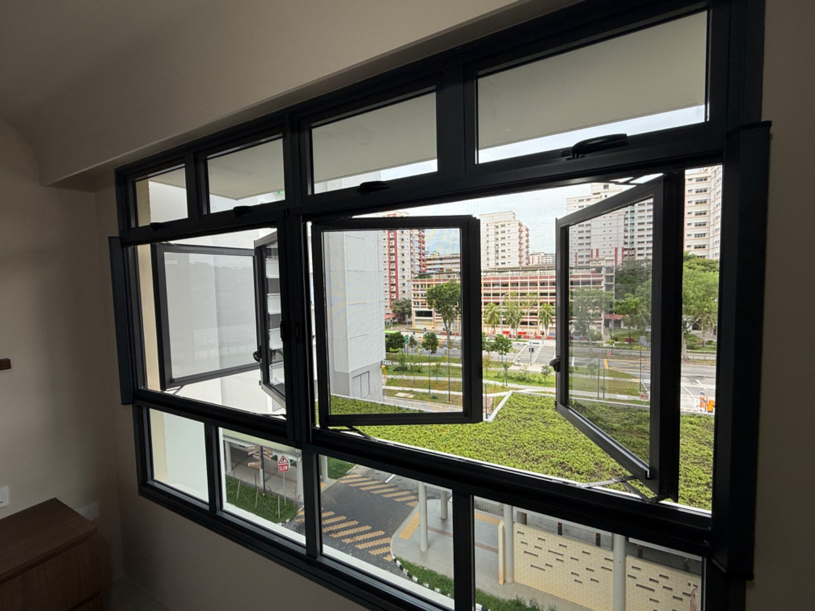 Retractable insect mesh fitted to a bright window in a Singapore home